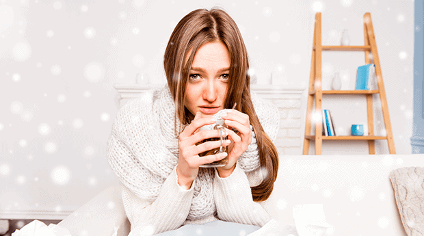 Woman in White Sick With Cold Holds Hot Drink