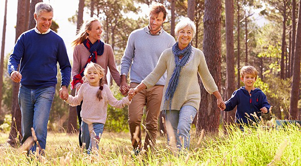 Happy multi-generation family walking in the countryside