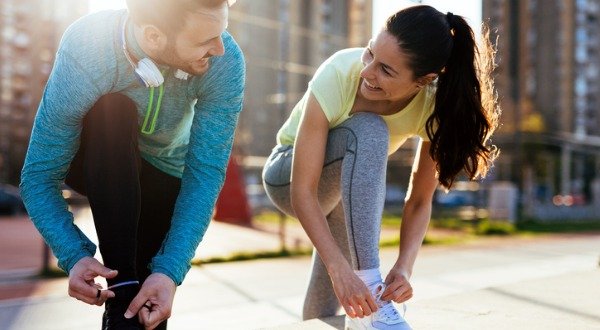 Runners tying their shoes, pre-workout